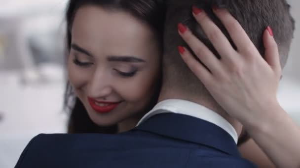 Young couple embrace and hold each other. Girl looks wistful and a little sad. — Stock Video