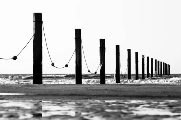 Gün batımında Middelkerke, Belçika yakınlarındaki Lombardsijde plajında kazık kafaları.