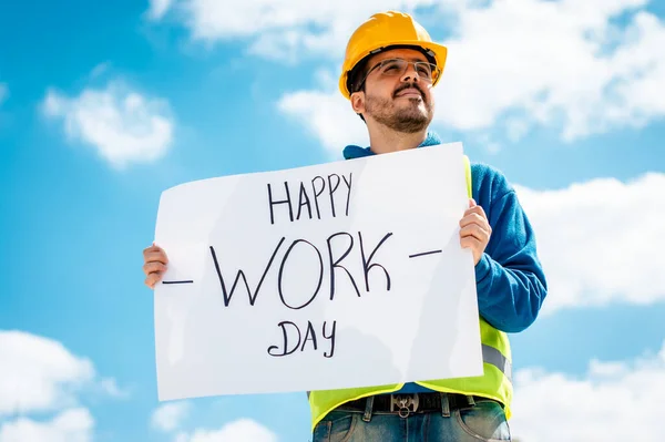 man with a sign that says happy work day