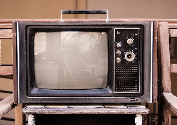 Retro TV, old television on a brick and wood background