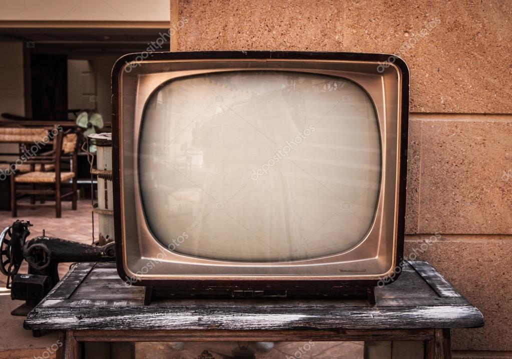 Retro TV, old television on a brick and wood background Stock Photo by