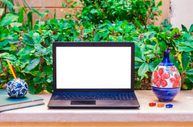 Laptop computer mock up with beautiful vases and pencils on wood
