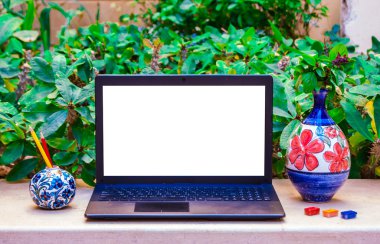 Laptop computer mock up with beautiful vases and pencils on wood