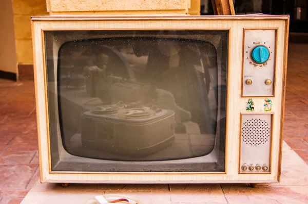 Retro TV, televisão antiga em um fundo de tijolo e madeira — Fotografia de Stock