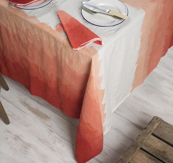 Dinnerware and Napkin on Table Covered in Gradient Orange Zigzag — Stock Photo, Image