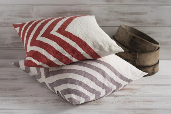 Stack of Two Throw Pillows with Chevron Design