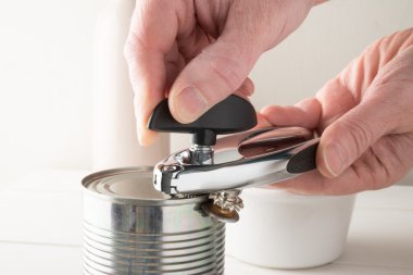 Tin Can Being Opened with a Side Opener clipart