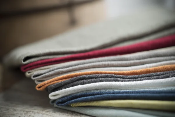 Pile of Folded Cotton Fabric on Wooden Surface — Stock Photo, Image