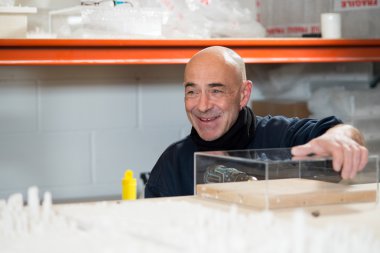 Delme sırasında bir akrilik durumda yerinde tutan adam