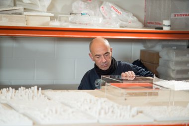 Akülü matkap şeffaf plastik bir çerçeve üzerinde çalışan adamla