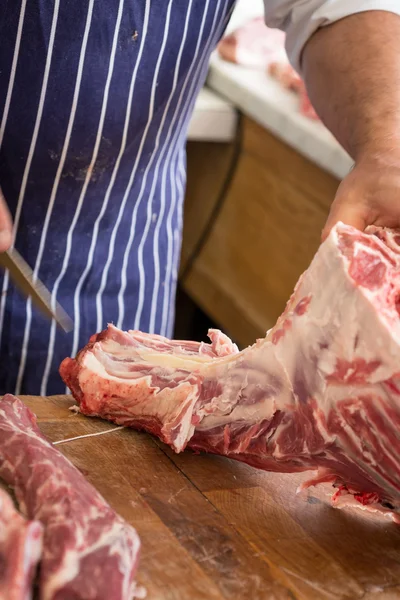 Butcher cutting large piece of meat — Stock Photo, Image