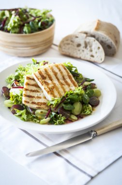 Haloumi and grape salad with mixed leaves clipart