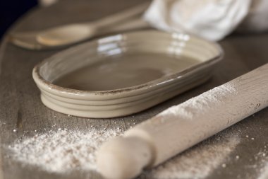Small shallow Baking Dish, Flour, and Rolling Pin on Counter
