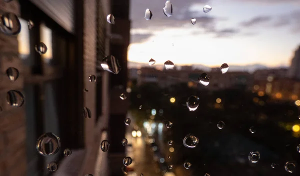 raindrops on the window looking at the night city