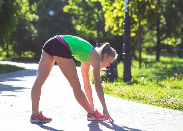 Junge Frau trainiert bei Sommertag im Stadtpark — Stockfoto