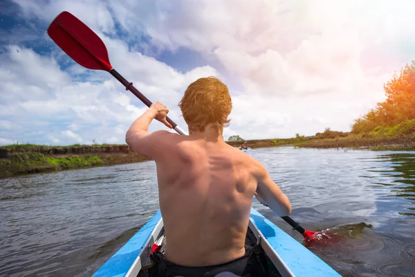 Young people are kayaking on a river in beautiful nature — Stock Photo, Image