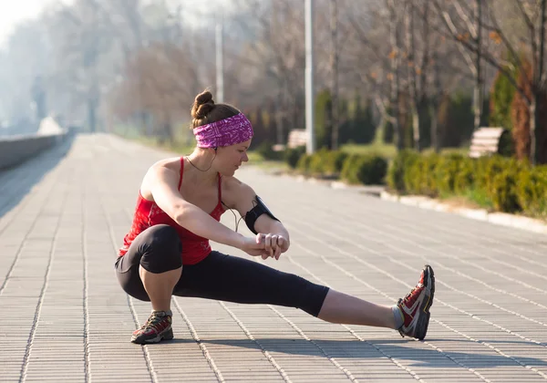 Mujer deportiva entrenando fuera en muelle de la ciudad por la mañana —  Fotos de Stock