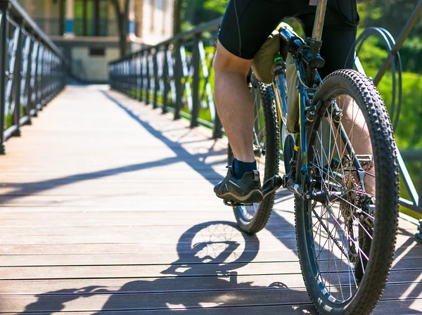 Велосипедист едет по дороге в городском парке — стоковое фото