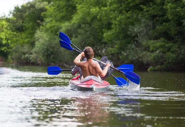 Young people are kayaking on a river in beautiful nature — Stock Photo, Image