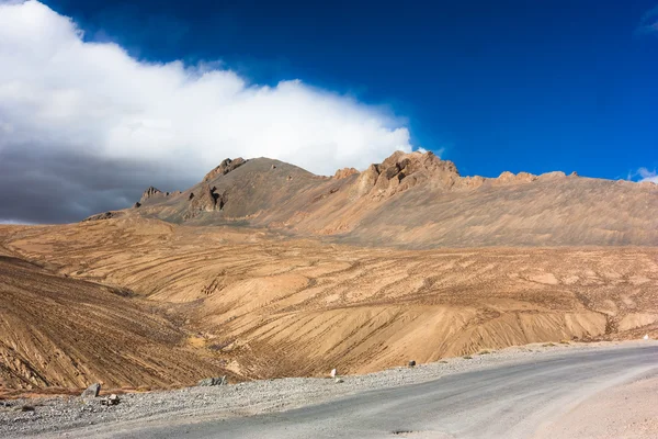 ヒマラヤ山脈の砂漠の山、道路、雲のある風景 — ストック写真