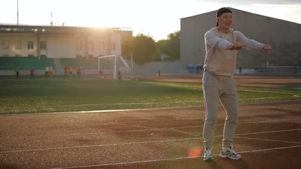 Young athletic man doing warm-up before exercise and jogging — Stock Video