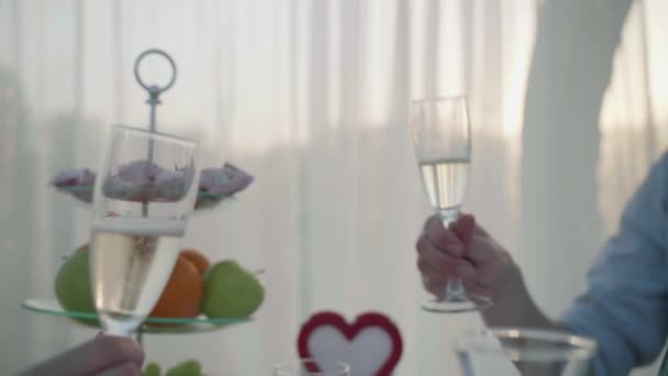 Шампанські окуляри на побаченні молодих пар — стокове відео