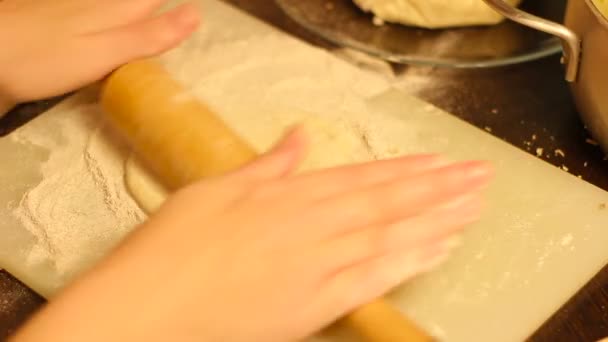 Rolling out dough with a rolling pin in hand — Stock Video