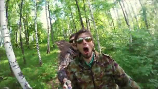 Двоє хлопців на квадроциклі їдуть лісом — стокове відео