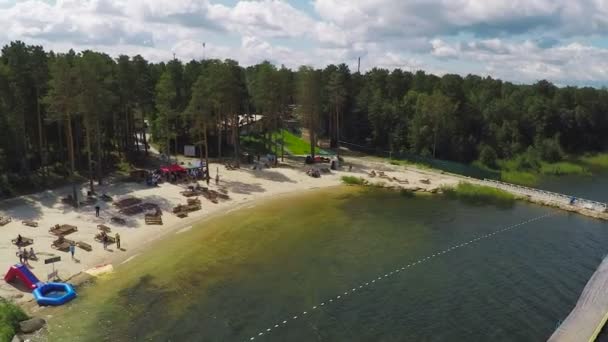Beau lac avec plage et les peuples des antennes — Video