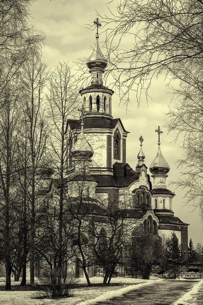 The Church of St. Sophia in the city of Kirov, Russia. The path to the temple is underlined by the road. The monochrome image emphasizes the importance of choosing the right path.