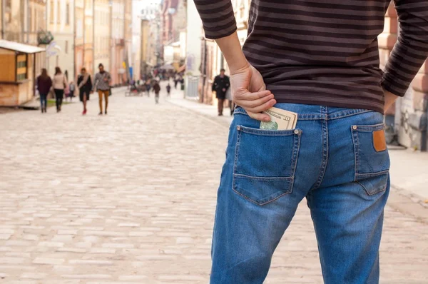 Man pulls the money from his jeans pocket, close-up