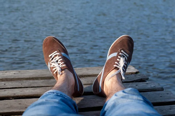 View of the lake on the pier with legs — Stock Photo, Image