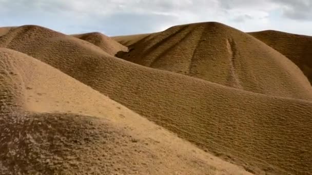 Un paysage unique de nature sauvage avec une vallée de dunes de sable jaune sur le fond d'une grande montagne rocheuse avec des sommets couverts de neige blanche. Un paysage merveilleux de l'environnement. — Video