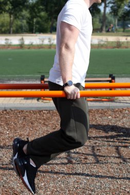 Yakışıklı seksi erkek vücut geliştirme sporcusu açık havada güneşli bir sabah sporu için içeri giriyor. Sağlıklı yaşam tarzı kavramı.