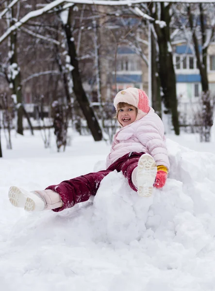 Child in winter. Girl rolling down the hills — Stock Photo, Image