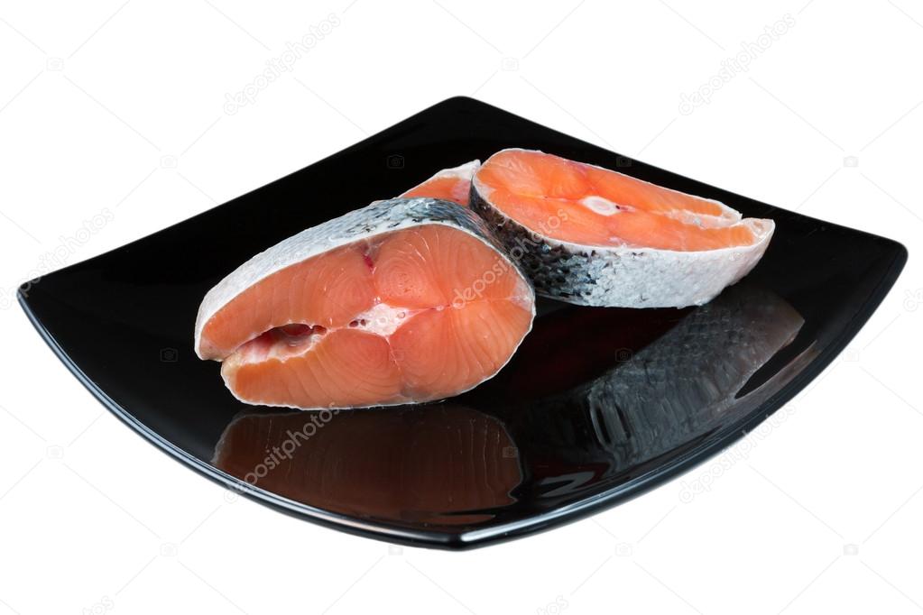 piece of salmon on black plate