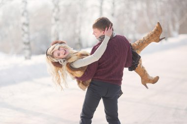 Happy Young Couple in Winter Park on Valentine's Day