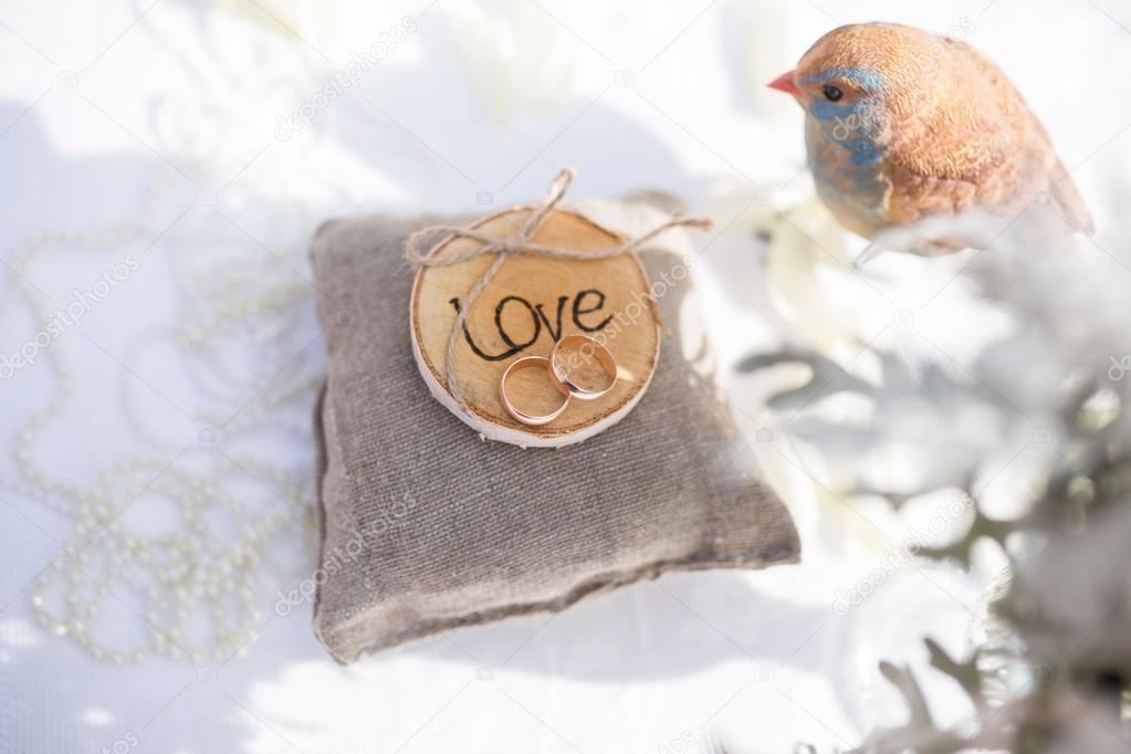 Two wedding rings on the pillow with love