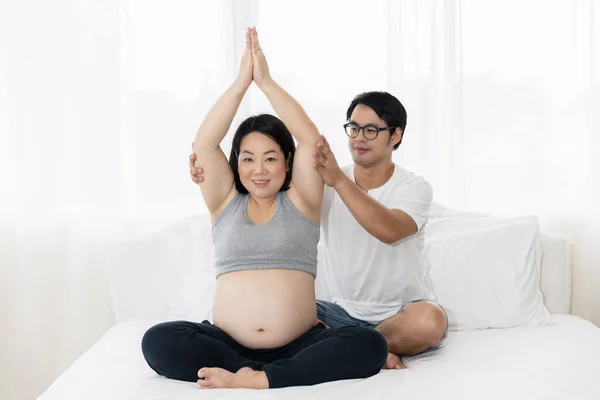 남편은 아내를 돌보고 아내에게 위에서 요가를 배경의 사랑돌보기 개념을 가르쳐 — 스톡 사진