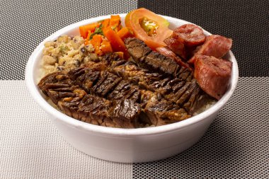 Brezilya beslenme çantasıyla ızgara et sosis salatası pirinç fasulyesi ve farofa.