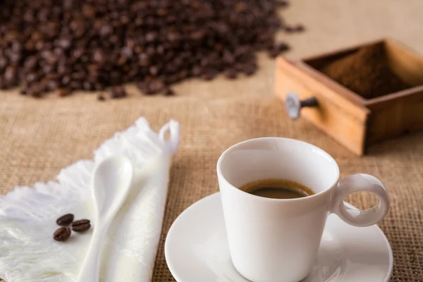 Coffee with coffee-beans on jute — Stock Photo, Image