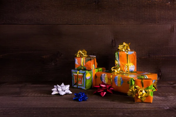 Many Christmas presents on planks background — Stock Photo, Image