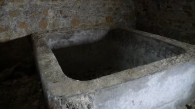 Ukrayna 'nın Ürkütücü Orta Çağ taş dondurucusundaki kırmızı tuğlalardan yapılmış eski uğursuz bir bodrumda, kırmızı tuğlalardan yapılmış ve Ukrayna' da küvete benzeyen eski bir yeraltı odasında. Çatlak, ürkütücü ve kendini beğenmiş görünüyor..