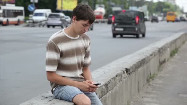 Homme assis à côté de la route — Video