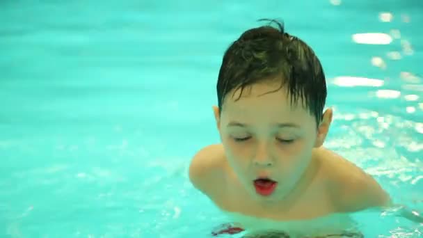Malý chlapec hraje v bazénu — Stock video