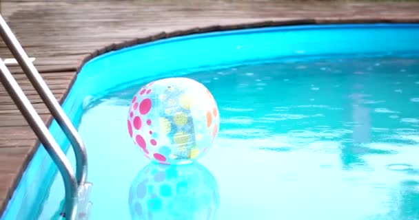 Raining at Swimming Pool With Inflatable Ball — Stock Video