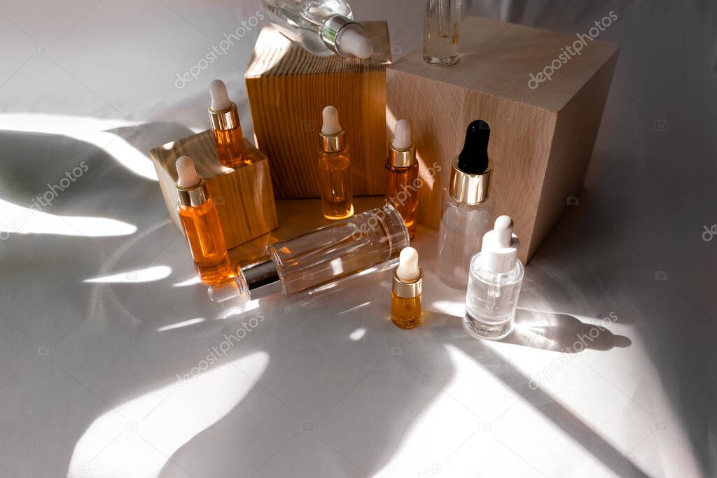 Natural hyaluronic serum on trendy abstrac background. Natural materials and skin care concept. Haed light  and shadows.