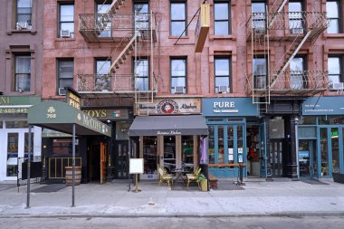 New York 'un Hell' s Kitchen bölgesi, harici yangın merdivenleri ve restoranları olan eski bir bina.