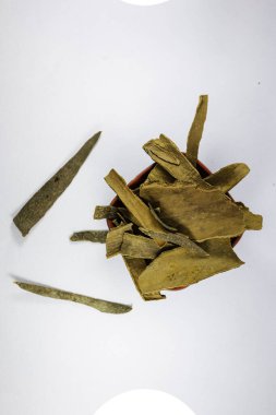 Beyaz arka planda izole edilmiş organik taze tarçın çubukları yığını. Kapat. en üstteki görünüm.