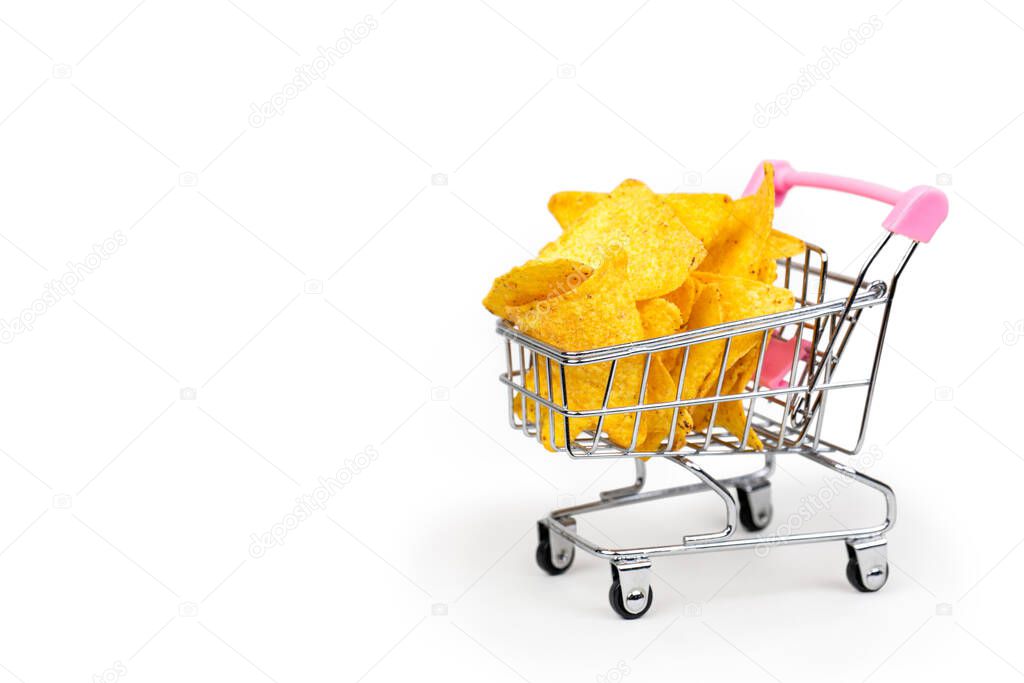 Cart full of corn chips tortilla on white background with place for text.